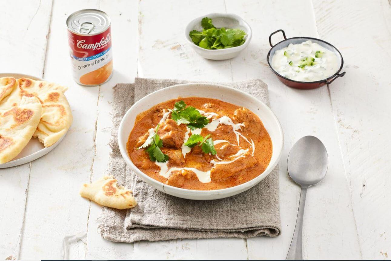 bowl of butter chicken curry with can of Campbell's Condensed Cream of Tomato Soup