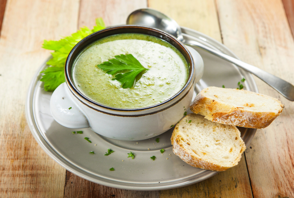 soup with parsley on top and bread on the side